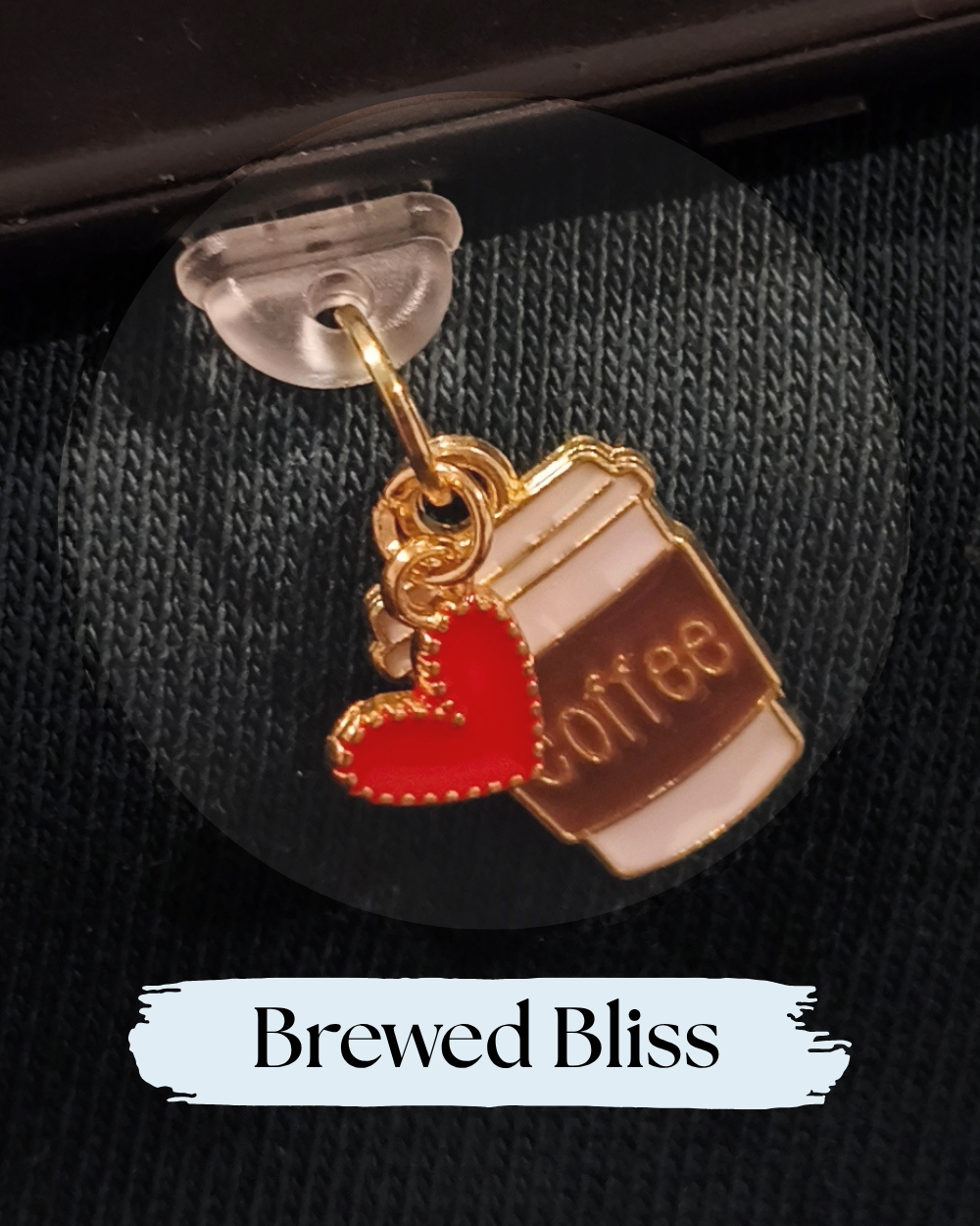 A gold-tone charm shaped like a coffee cup with a red heart and the word 'coffee' on the cup, displayed on a black textured background with a clear stand. Dust plug for Kindle or e-reader, Kindle Accessory, One More chapter
