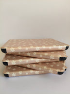 One More Chapter Premium Kindle Case in Petals & Prologues – five blush pink floral folio cases stacked flat, angled top-down view