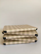One More Chapter Premium Kindle Case in Booked for Brunch – five cases stacked flat, side-on view, sage and cream gingham