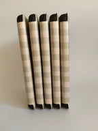 One More Chapter Premium Kindle Case in Booked for Brunch – five cases laid flat showing spine detail, sage and cream gingham