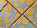 One More Chapter Premium Kindle Case in Lemon Grove – close-up of lemon slice print texture on sky blue folio surface