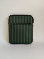 One More Chapter E-reader Sleeve in Midnight Library – single padded sleeve front view showing front pocket, deep forest green tonal stripe with dark zip closure