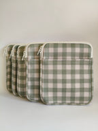 One More Chapter E-reader Sleeve in Booked for Brunch – four sage green and cream gingham padded sleeves lined up, angled front view showing zip and front pocket