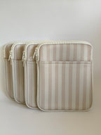One More Chapter E-reader Sleeve in Barista Blend – four warm cream and taupe stripe padded sleeves lined up, angled front view showing zip and front pocket