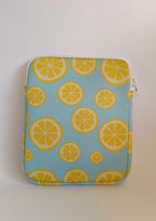 One More Chapter E-reader Sleeve in Lemon Grove – single padded sleeve back view, sky blue with yellow lemon slice print and white zip closure