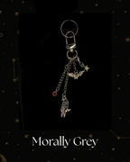 A silver-toned gothic keychain featuring a raven, bat, and star charms, with a small red gem accent, Kindle Accessory, for Kindle, Kobo, One More Chapter