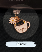 Dust plug for Kindle or e-reader,  black-and-white cat charm peeking out of a cream-colored teacup, with a daisy flower attached. for Kindle, Kindle Accessory, One More Chapter