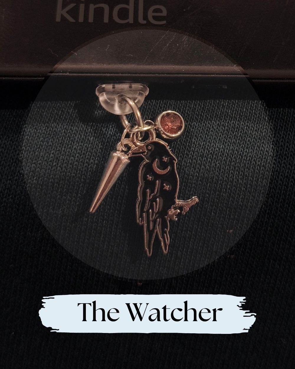 Dust plug, charm for Kindle or e-reader, A gothic-style charm accessory featuring a black raven with a crescent moon and stars, a metallic spike, and a small amber gem, Kindle Accessory, Kindle, Kobo, One More Chapter