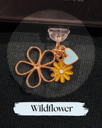 Dust plug for Kindle, e-reader, A gold-tone flower charm accessory with a four-petal outline flower, a yellow daisy charm, and a light blue enamel heart charm, Kindle Accessory, for Kindle, Kobo, One More Chapter